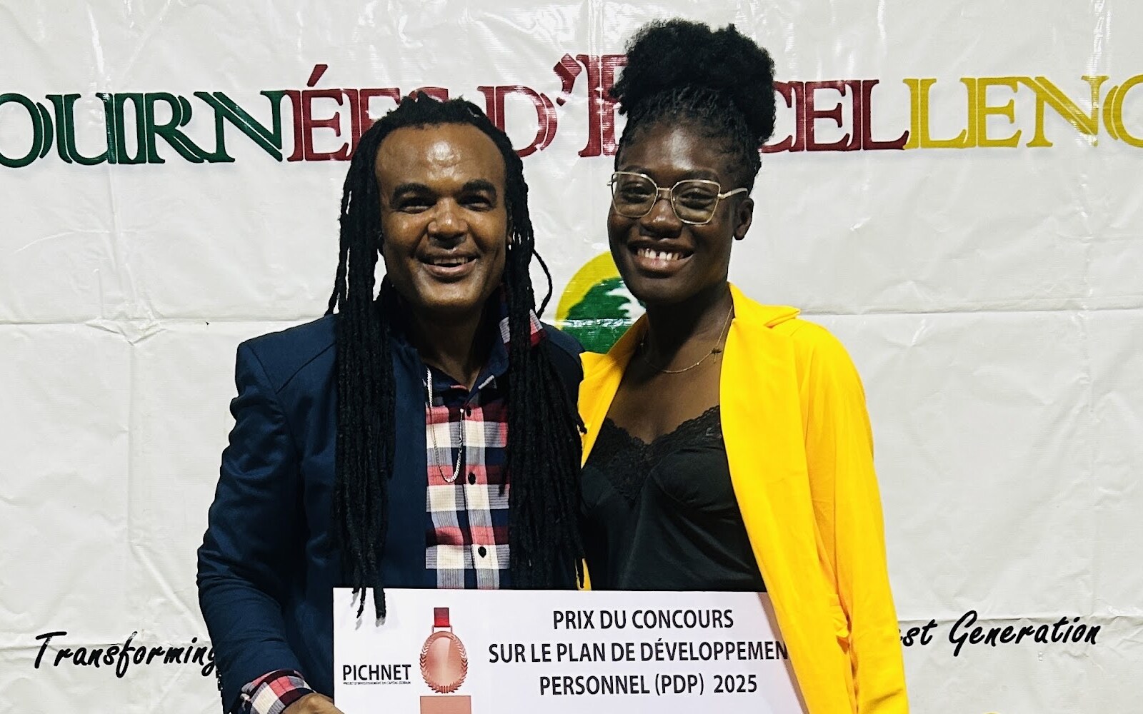 A PICHNET competition prize recipient holding an award check.