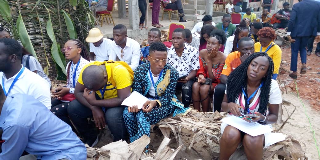 Young participants seated outdoors during a PICHNET workshop session.