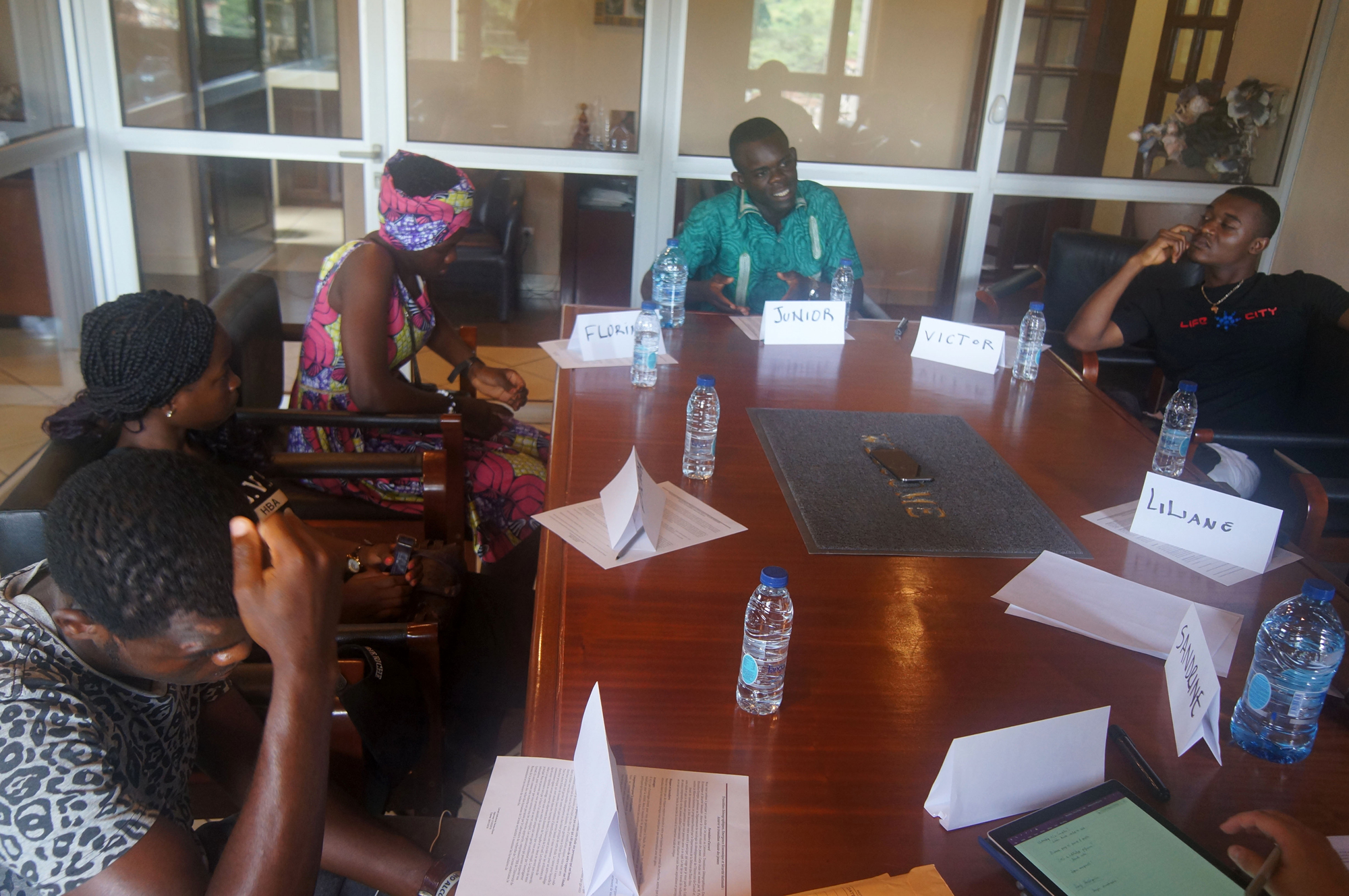 Young participants seated around a table during a facilitated discussion.
